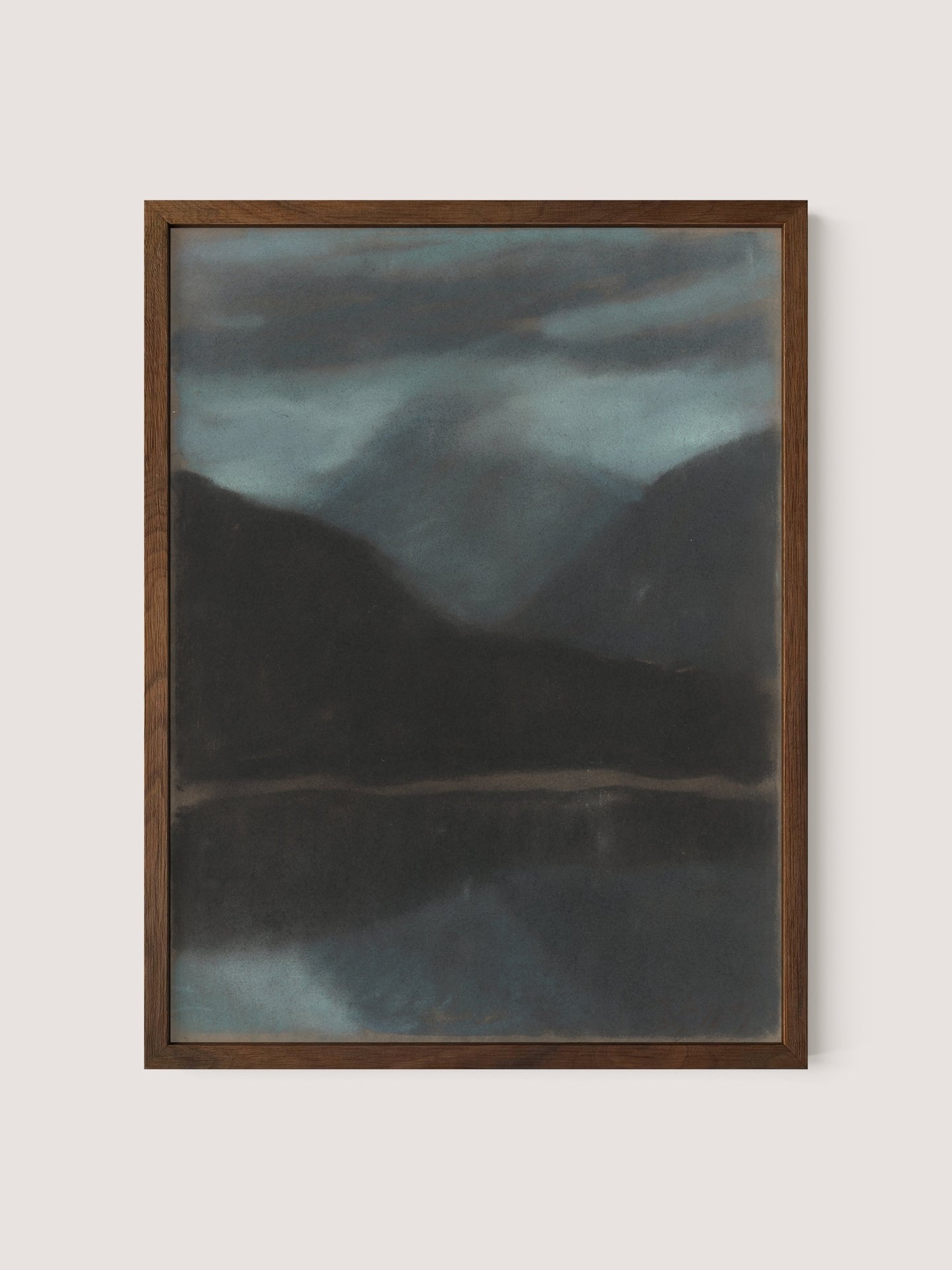 Evening in Štrbské Pleso" is a framed painting of a tranquil landscape composition featuring misty, dark mountains and a reflective body of water beneath a moody, cloudy sky. The frame is made of dark wood, beautifully showcasing this timeless work of art.