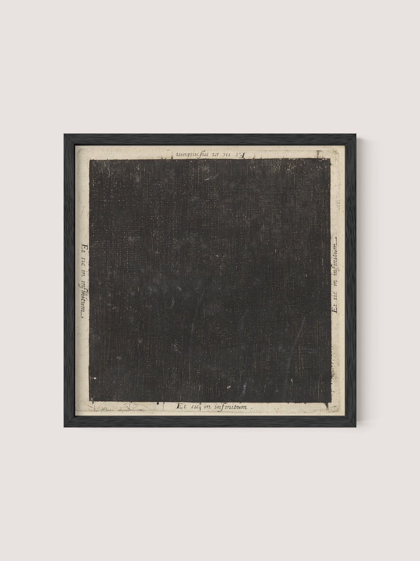 The "Cosmic Square" is a framed artwork featuring a predominantly black square canvas with a textured, dark surface. The square is bordered by a white margin adorned with handwritten notations and numbers around the edges, reminiscent of 17th-century etching. The frame is simple and finished in Black Oak, providing a minimalist look.