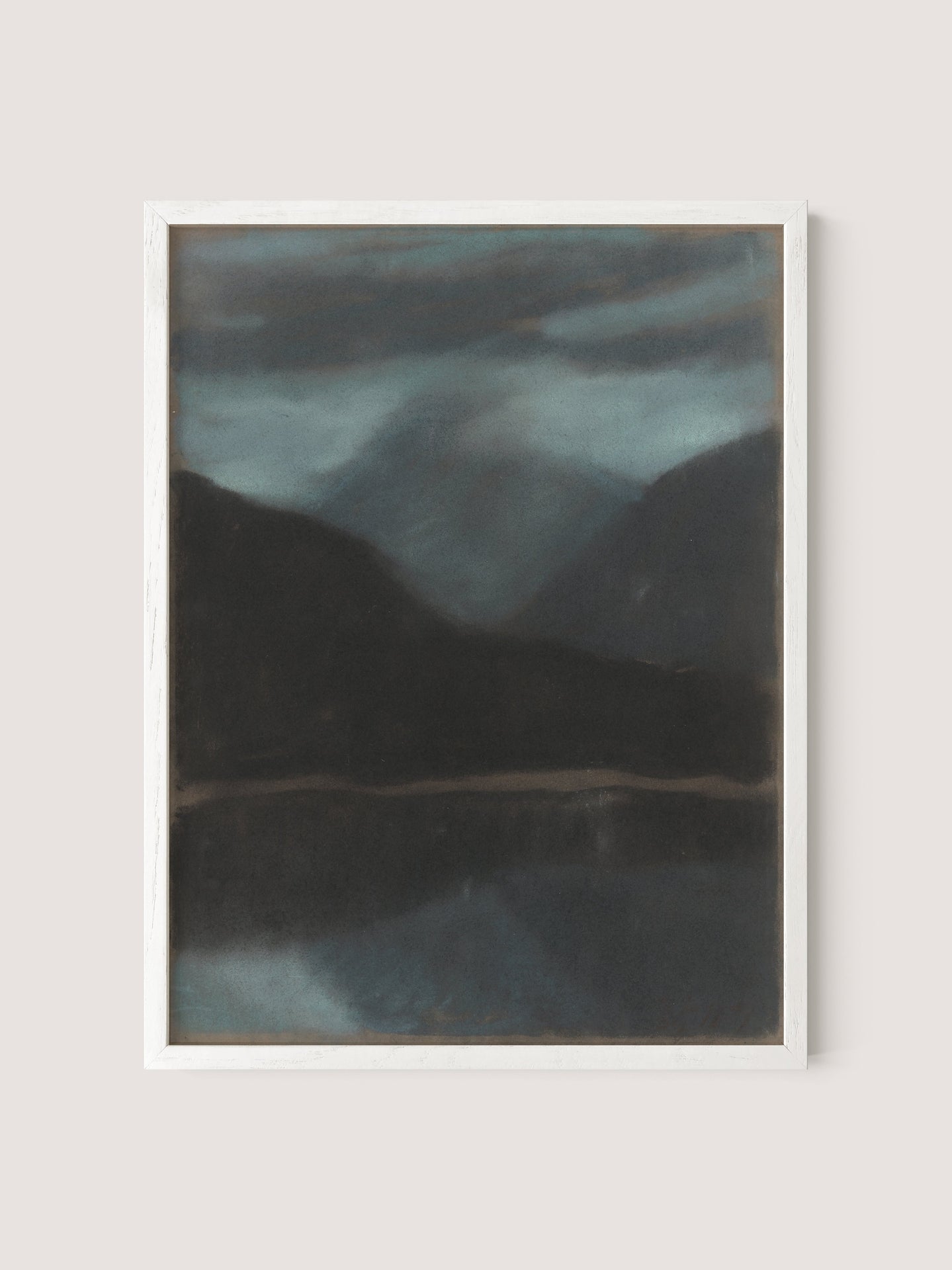 The framed painting, "Evening in Štrbské Pleso," captures a moody landscape with dark mountains mirrored in a still body of water, all beneath a cloudy, dimly lit sky. This timeless piece primarily employs muted blues and grays.