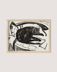A framed artwork titled "Lying Cat" features a black cat resting on a curved surface. The drawing, composed in a monochromatic palette, emphasizes bold lines and contours, giving the piece a minimalist, abstract feel. The cat appears relaxed amidst the simple background, showcasing the artist's refined vision. The artwork is elegantly framed in natural oak.