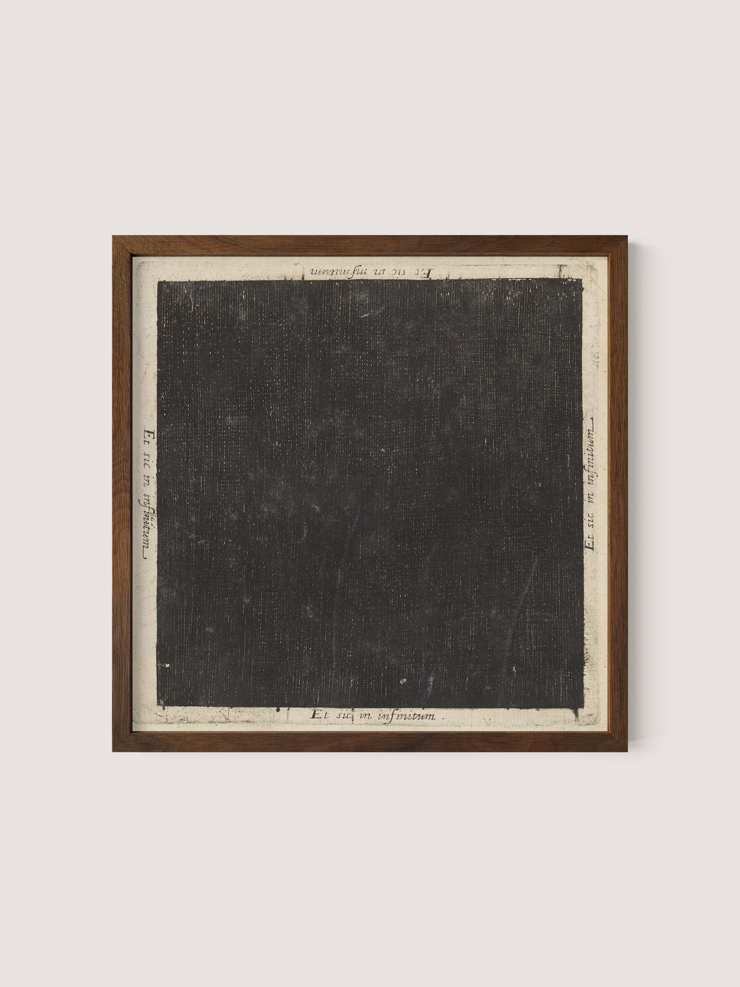 Introducing the Cosmic Square: a framed piece of art reminiscent of Flood's seminal work. It features a large, textured black square with a light grey border. Various small handwritten notes and mathematical notations are artistically scattered around the edges of the square on the border. The frame is elegantly crafted from Walnut Oak wood.