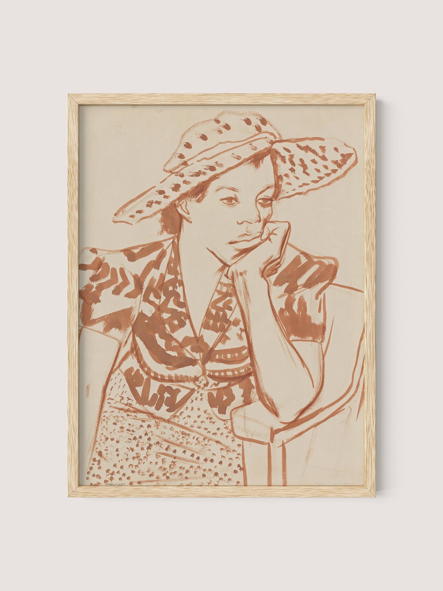 The "Seated Woman With Hat at Studio" is a framed line drawing depicting a person in a thoughtful pose, adorned in a large, patterned hat and an intricately detailed outfit. The reddish-brown lines create a striking contrast against the light beige background, making it an ideal addition to any gallery wall. The frame is finished in elegant natural oak.