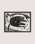 A framed "Lying Cat" print in a Black Oak finish showcases a black and white drawing of a cat lounging on its side against a Kirchner-inspired abstract background. The art style is loose and sketch-like, capturing the relaxed posture of the feline with expressive lines that emphasize the artist's vision.