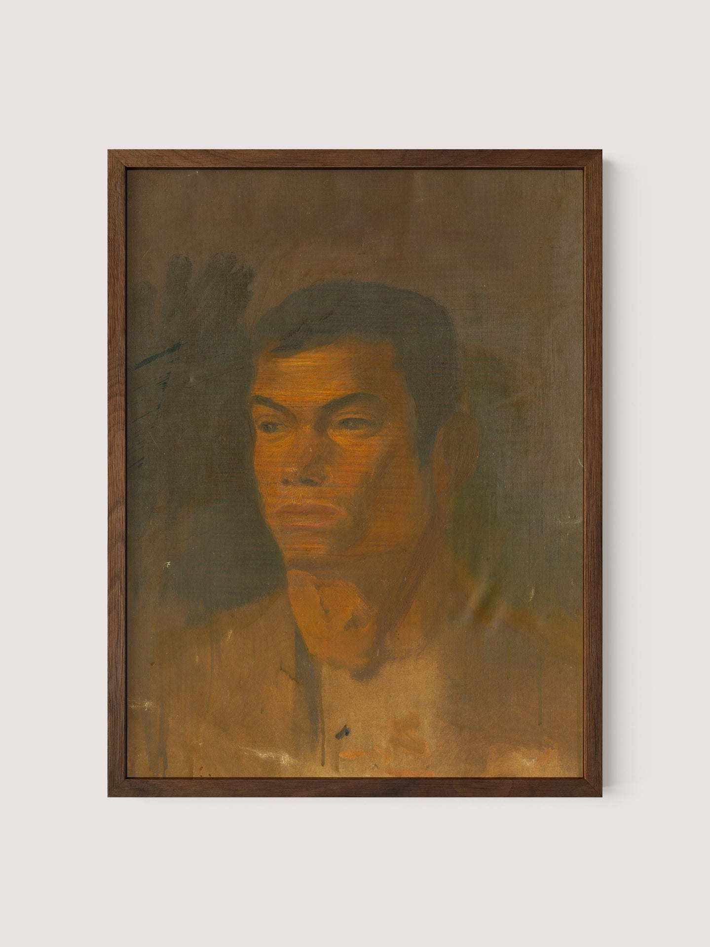 Head of a Gypsy Boy" is a framed painting featuring a solemn-faced man with short dark hair against a muted brown background. Reminiscent of Ladislav Mednyánszky's style, this artwork employs earthy tones and presents a somewhat textured surface that imparts a rustic, unfinished appearance. The portrait exudes sophisticated timeless décor as the man gazes forward with a serious expression. The frame in Walnut Oak completes this striking piece, adding to its elegance and charm.