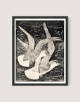 Flying Seagulls," a framed black-and-white drawing by van Hoytema, depicts two seagulls in flight against a textured background. The seagulls have their wings spread wide, and the intricate details capture the motion and grace of their flight within a natural world. The piece is elegantly framed in Black Oak.