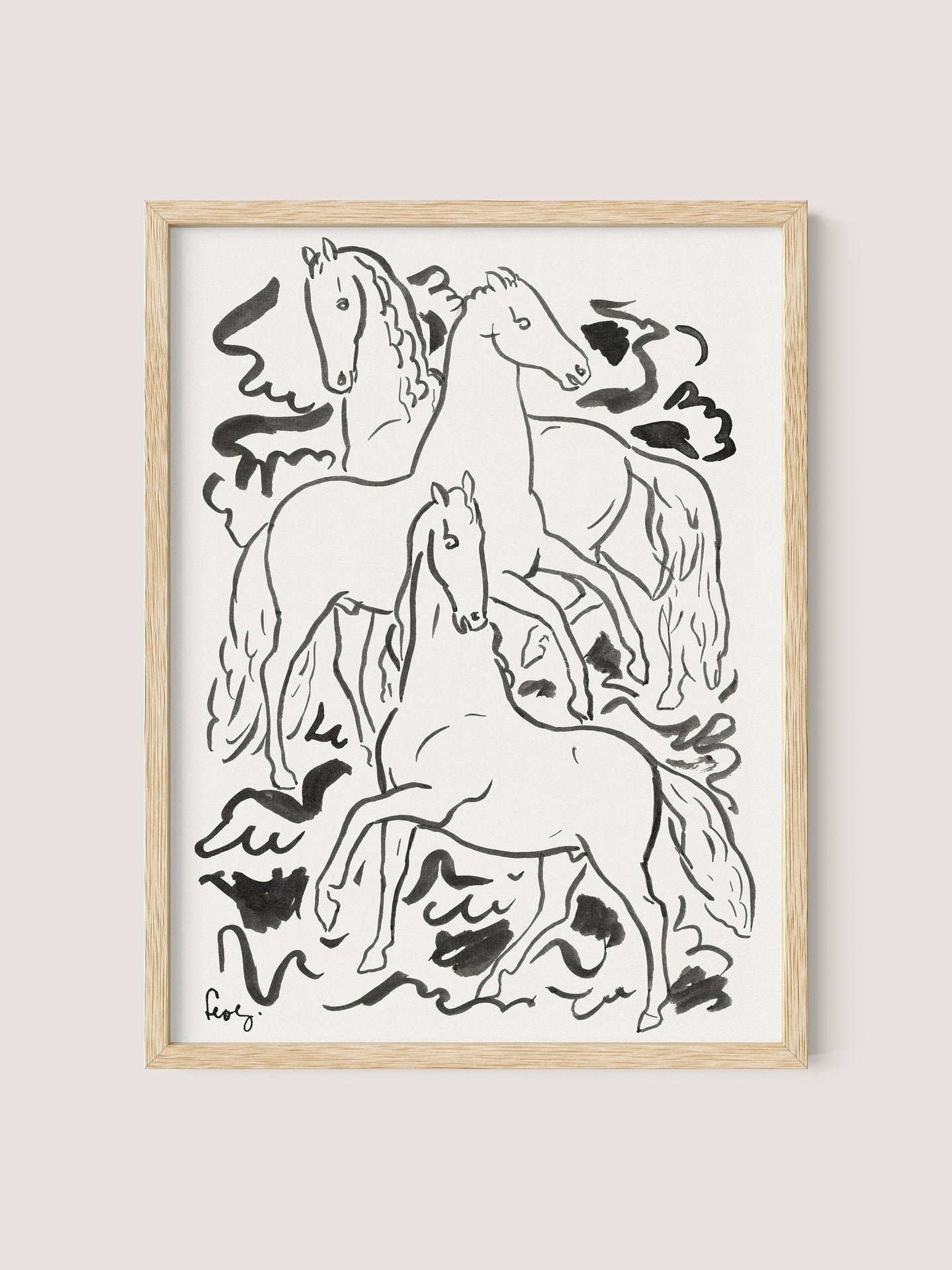 A minimalistic black and white ink drawing in a natural oak frame depicts three horses in various dynamic poses, set against a simple background with abstract shapes. The Three Horses print is signed by Leo Gestel at the bottom left corner.

