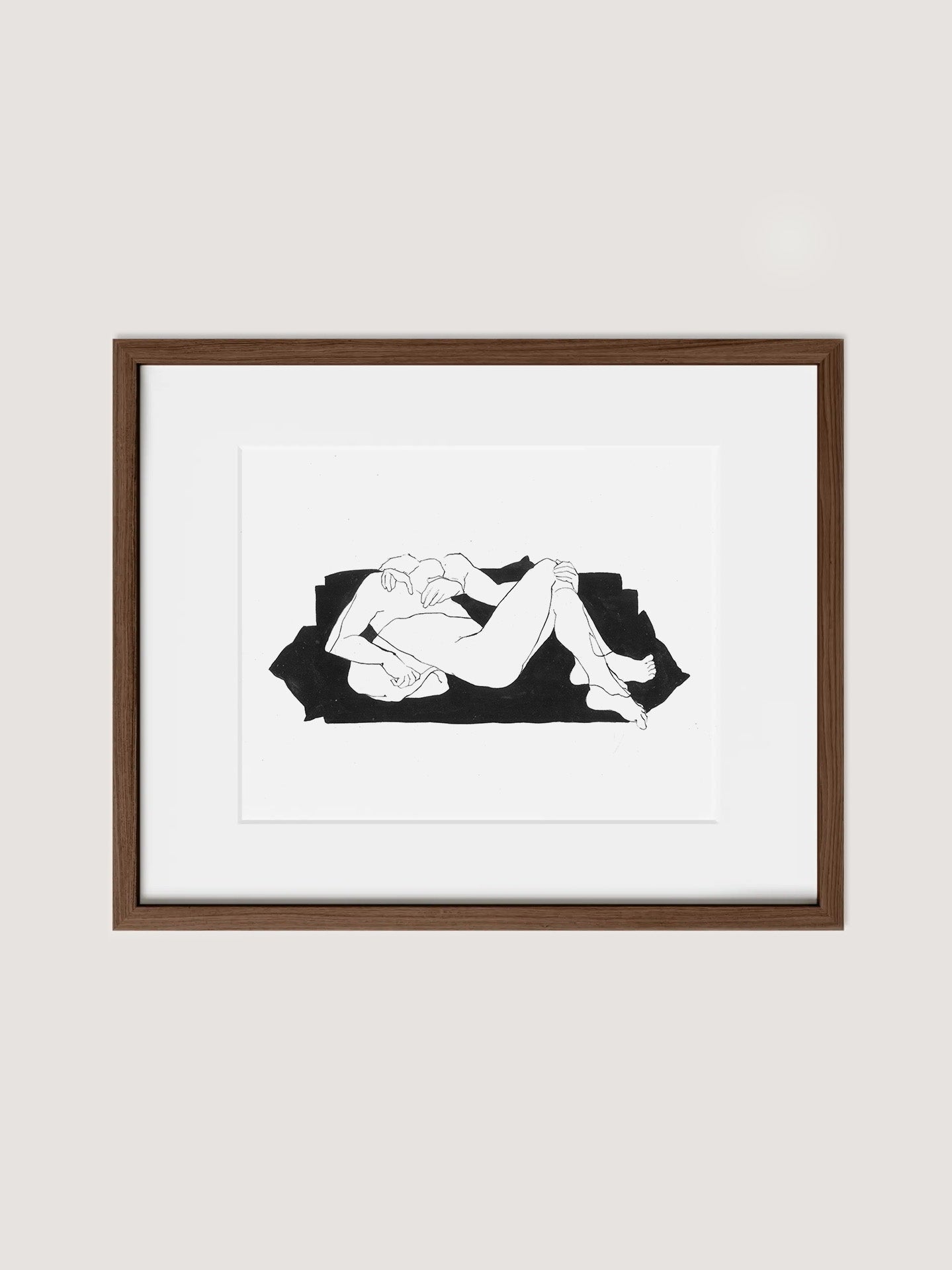 The "Samantha Michell III" framed minimalist art print features an original ink drawing of a reclining nude figure against a dark, irregular background. The print is elegantly displayed within a wooden frame made from walnut premium oak and centered within a white matte border, hung on a light-colored wall. This exceptional piece is part of an exclusive edition of 10.