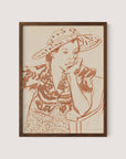 The Seated Woman With Hat at Studio depicts a pensive person resting their chin on their hand. Seated on a chair, the individual dons a wide-brimmed, patterned hat and a patterned blouse. The line drawing, framed in walnut oak, features earthy brown tones on a neutral background, making it an ideal piece for any gallery wall.