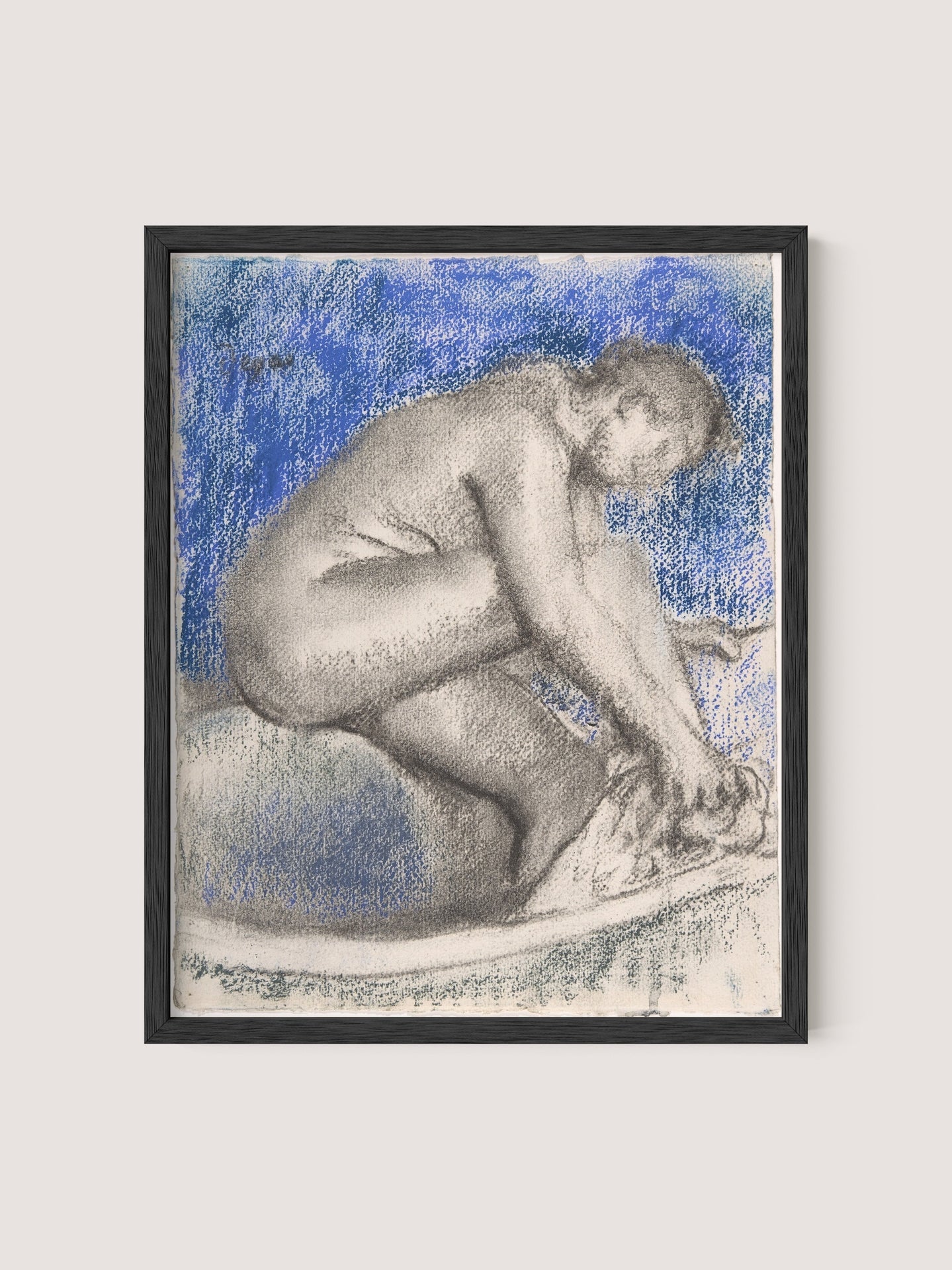 The Bath is an artwork featuring a person crouching and washing their feet, rendered in charcoal or pencil with a blue background that emphasizes the figure's intimate introspection. The entire drawing, evocative of an impressionist style, is set in a Black Oak frame.