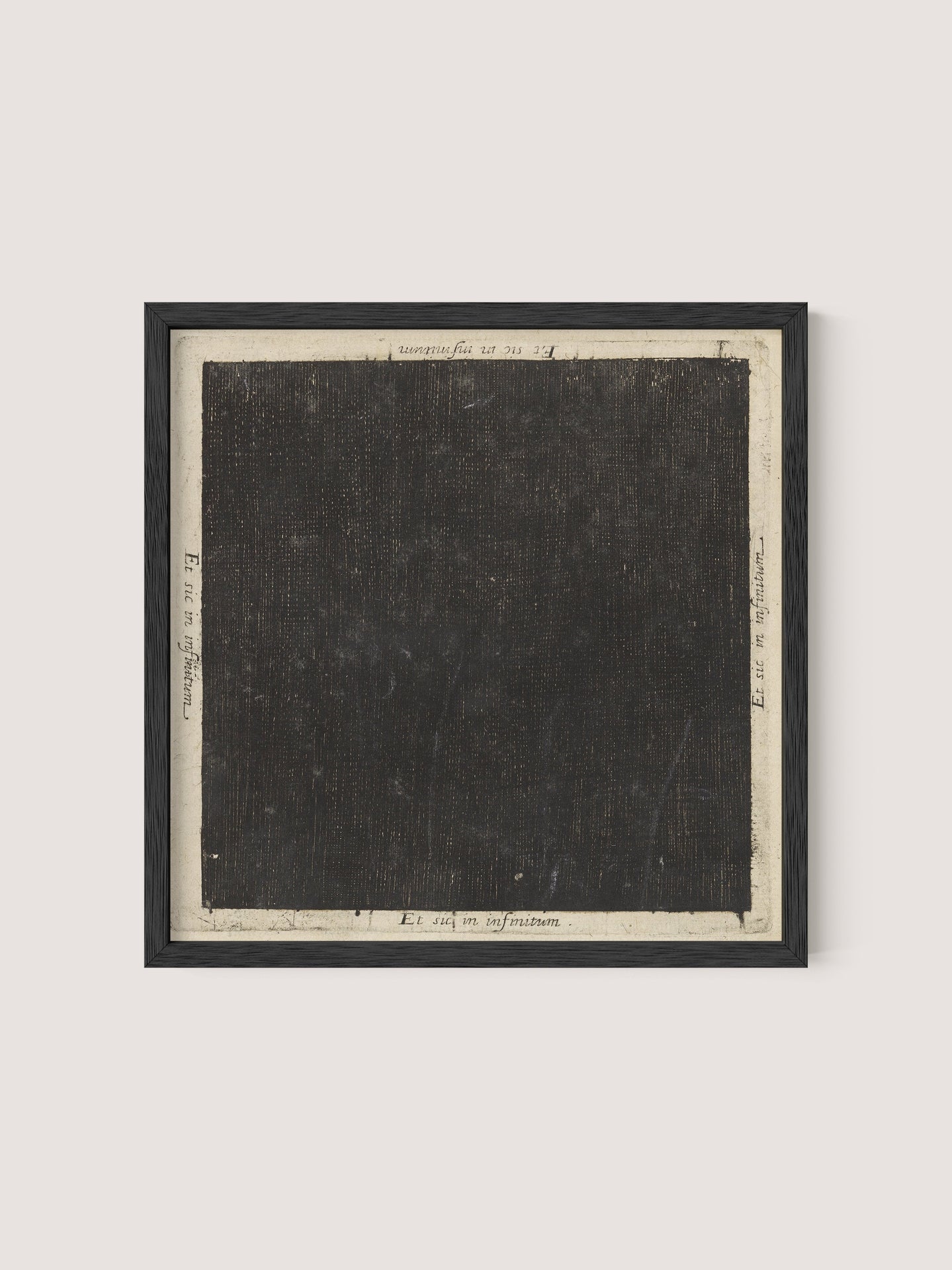 The "Cosmic Square" is a framed artwork featuring a predominantly black square canvas with a textured, dark surface. The square is bordered by a white margin adorned with handwritten notations and numbers around the edges, reminiscent of 17th-century etching. The frame is simple and finished in Black Oak, providing a minimalist look.