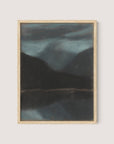 A framed painting titled "Evening in Štrbské Pleso" captures a moody, dark landscape composition with mountains and a reflective lake under a cloudy sky. The hues are muted, featuring deep greens and blues, creating an atmospheric and serene scene. The light wooden frame adds to its timeless work of art appeal.