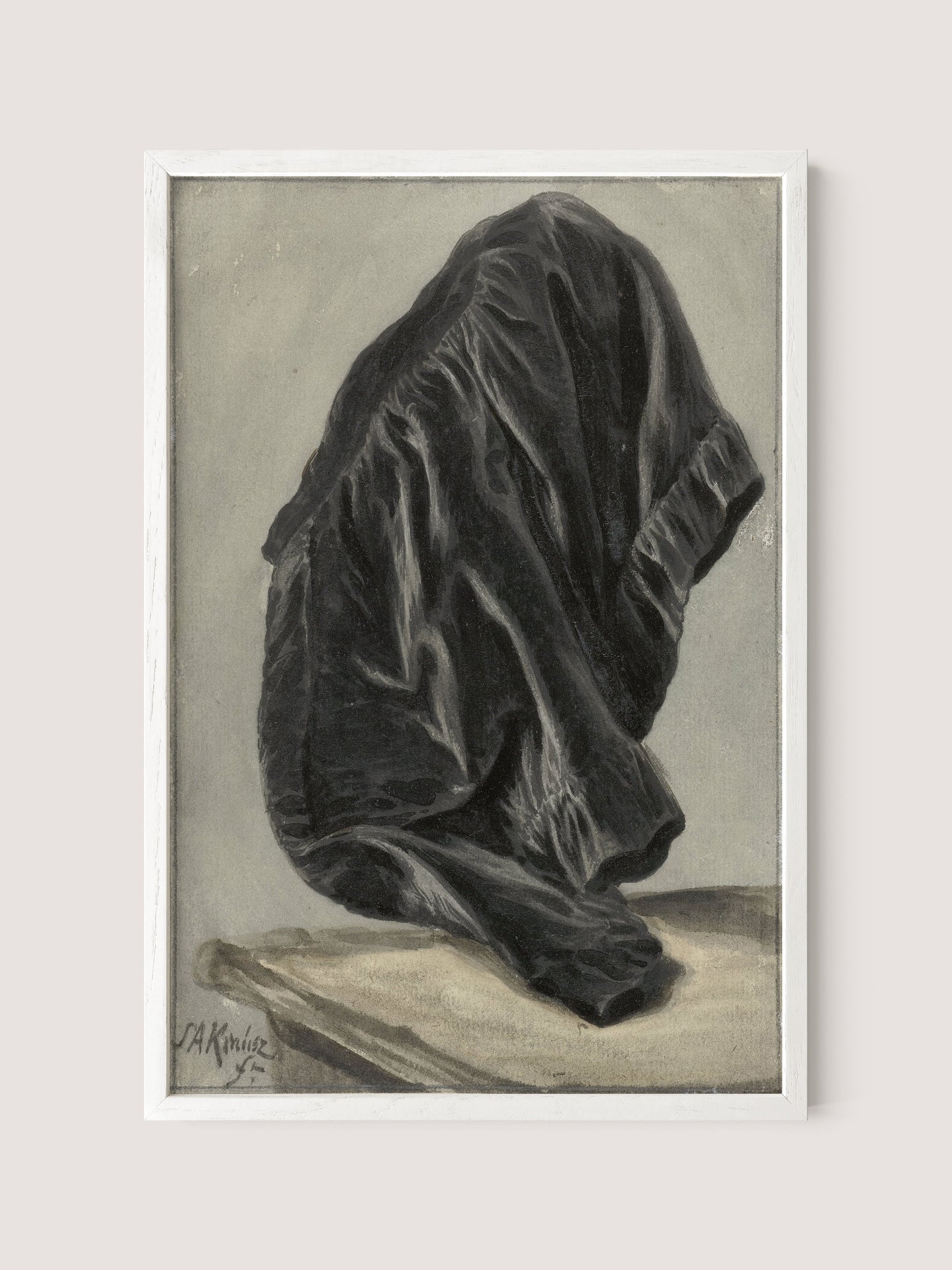 The framed artwork titled "Drape Study" features a detailed depiction of a crumpled black garment carefully draped over an unseen object. The intricate folds and shadows create a highly realistic texture, beautifully capturing the interplay of light and darkness. Set against a neutral gray background, the monochrome study is further emphasized. The artist's signature can be found in the bottom left corner. This piece comes in an elegant White Oak frame.