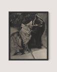 The Serenaders," a framed black and white print, captures a touching moment between feline friends. The photograph shows two cats sitting closely together—one with a striped pattern on the left and a solid black cat grooming its companion on the right—beautifully framed in Black Oak.