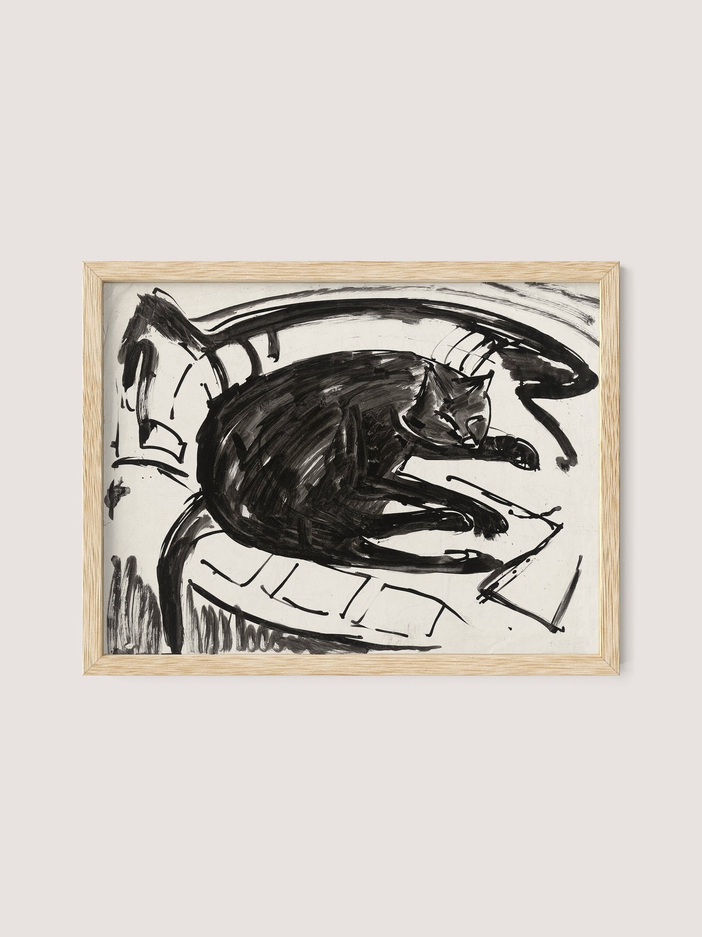 A framed artwork titled "Lying Cat" features a black cat resting on a curved surface. The drawing, composed in a monochromatic palette, emphasizes bold lines and contours, giving the piece a minimalist, abstract feel. The cat appears relaxed amidst the simple background, showcasing the artist's refined vision. The artwork is elegantly framed in natural oak.