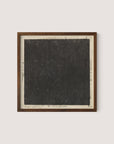 Introducing the Cosmic Square: a framed piece of art reminiscent of Flood's seminal work. It features a large, textured black square with a light grey border. Various small handwritten notes and mathematical notations are artistically scattered around the edges of the square on the border. The frame is elegantly crafted from Walnut Oak wood.