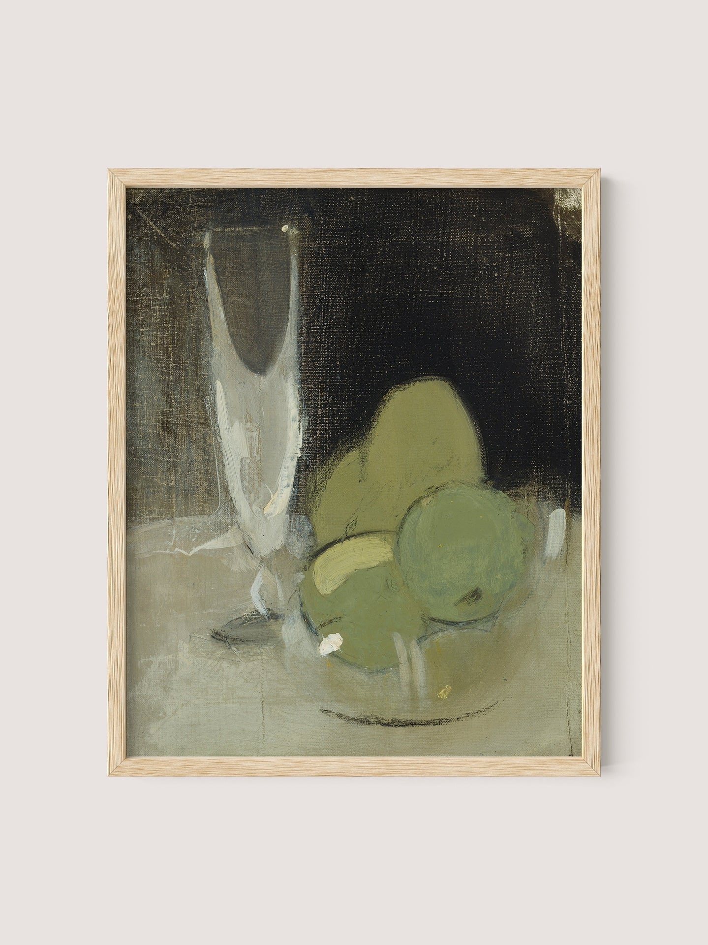 A framed painting titled "Green Apples And Champagne Glass" depicting a still life with green apples and a champagne glass on a table. The painting, distinguished by its muted earth tones, emphasizes a minimalist and expressive style, encapsulating timeless elegance. The frame is crafted in natural oak color.