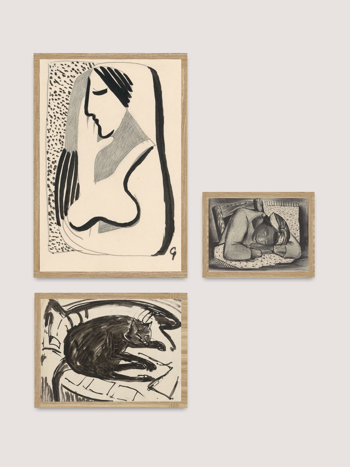 The Art Wall II features three framed black-and-white art pieces displayed on a white wall, creating a dynamic exposition. The top piece is an abstract portrait of a woman, the bottom left showcases a cat resting on a blanket, and the bottom right depicts a person sleeping on their side on a bed.