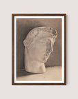 The framed monochromatic sketch, titled "Study of a Plaster Head," features a neoclassical-style marble bust of a male head with curly hair. The head is turned slightly to the right, and the background is shaded in darker tones, enhancing the minimalist elegance of the Walnut Oak piece.