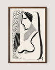 A framed minimalist ink drawing titled "Thoughtful Woman" showcases a black and white profile of a woman with long hair. Using bold, sweeping lines and minimalistic details, this artwork creates a stylized and modern depiction. The versatile design is enhanced by a textured pattern on the left side, making it perfect for various interior styles. This piece comes in an elegant Walnut Oak frame.