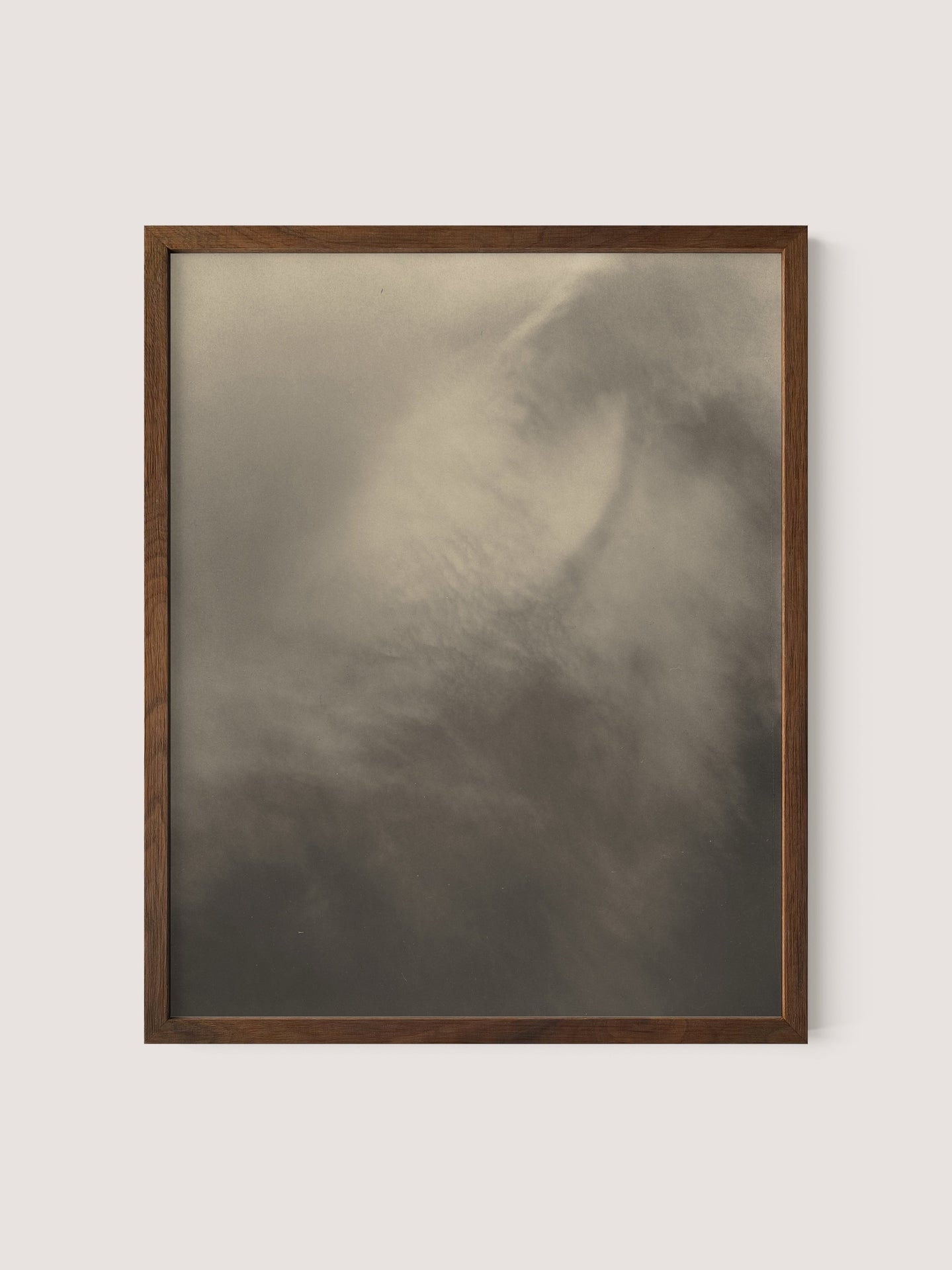 A framed photograph titled &quot;Equivalents,&quot; reminiscent of Alfred Stieglitz&#39;s &quot;Songs of the Sky,&quot; features a soft, abstract depiction of clouds or mist in shades of gray and white. The image, a gelatin silver print, appears tranquil and atmospheric with gentle contrasts and subtle details suggesting movement. The wooden frame has a simple, natural Walnut Oak finish.