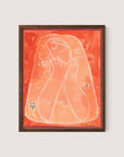 The minimalist painting, "Thoughtful Woman II," features abstract artwork of a veiled figure with closed eyes and clasped hands, painted in warm shades of orange, pink, and red. It is framed in a simple walnut oak frame and adorned with small floral elements in the corners. Galanda's signature is visible at the bottom.