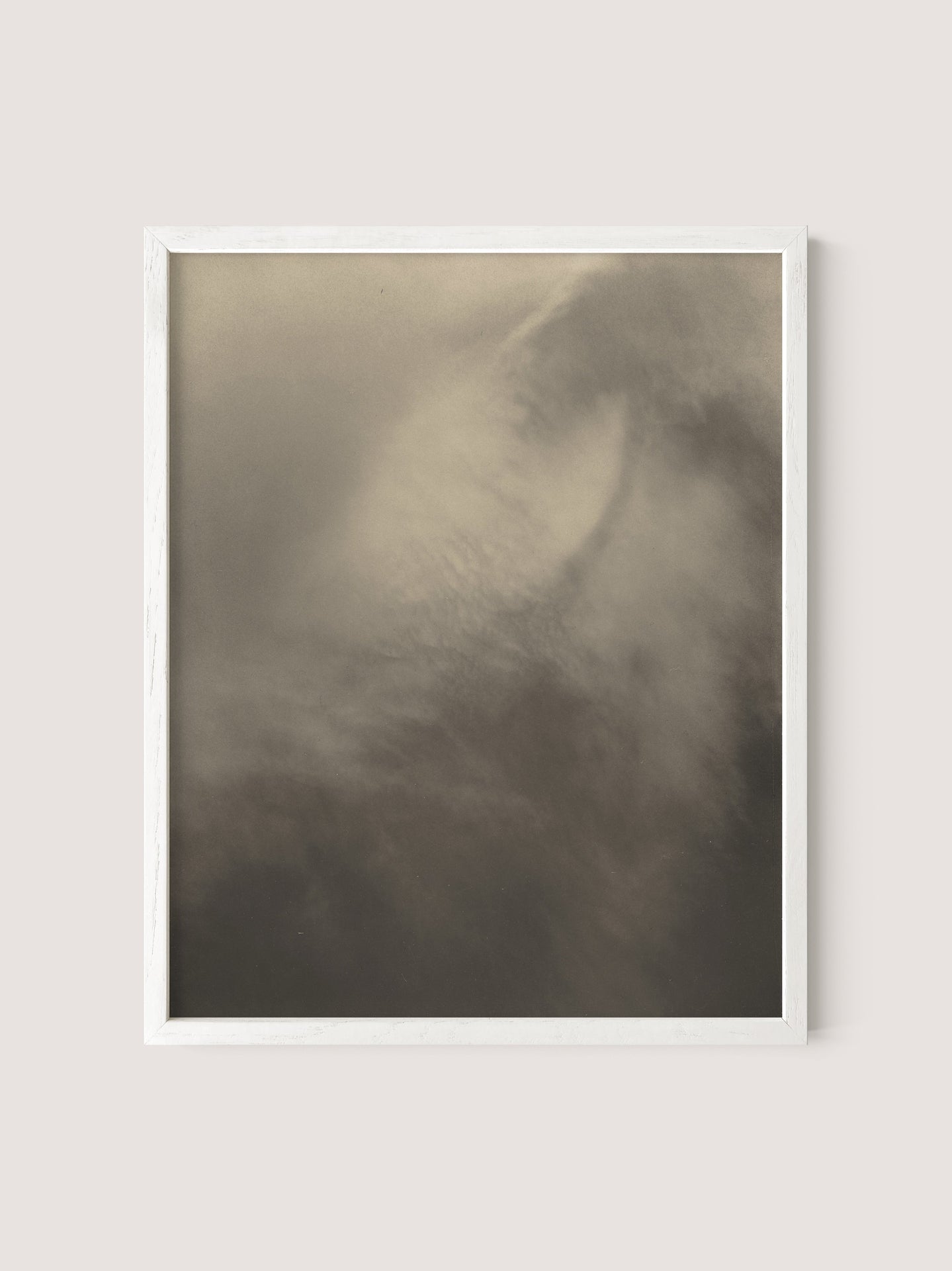 A framed photograph, reminiscent of Alfred Stieglitz's *Songs of the Sky*, features an abstract misty scene with soft, muted tones of gray and beige, evoking a calming and serene atmosphere. Titled "Equivalents," the image is a delicate gelatin silver print, enclosed within a simple White Oak frame and set against an off-white background.