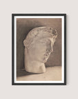 The "Study of a Plaster Head" is a framed pencil sketch of a neoclassical statue head in Black Oak, featuring fine, detailed lines and shading. The head, with curly hair and a serene expression, is tilted slightly to the right. The shaded background lends elegance and depth, enhancing the three-dimensional effect.