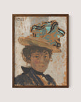 The framed painting print titled "Madame Bonnard" portrays a woman with a neutral expression, adorned in a large hat featuring blue and tan tones, and dressed in a dark-colored outfit. The artwork showcases textured, impressionistic brushstrokes reminiscent of Edouard Vuillard’s style, evoking a vintage and expressive ambiance. The frame is available in the elegant Walnut Oak color.