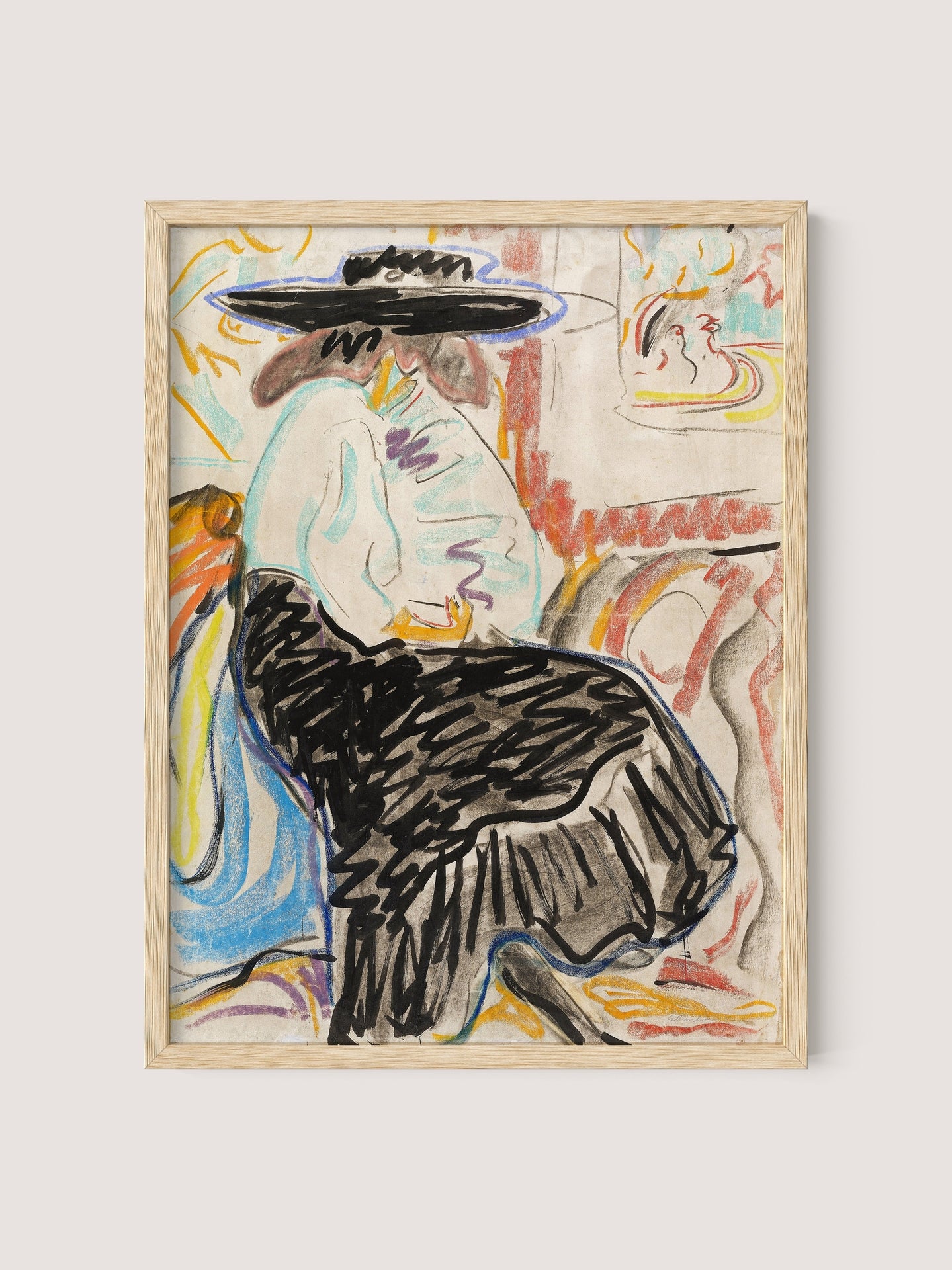 A framed painting titled "Seated Woman in the Studio" features a person sitting, wearing a large black hat, a light-colored top, and a black skirt. The background is colorful and abstract, with dynamic brushstrokes and various shapes, reminiscent of Kirchner's figurative art style. The frame comes in a natural oak finish.