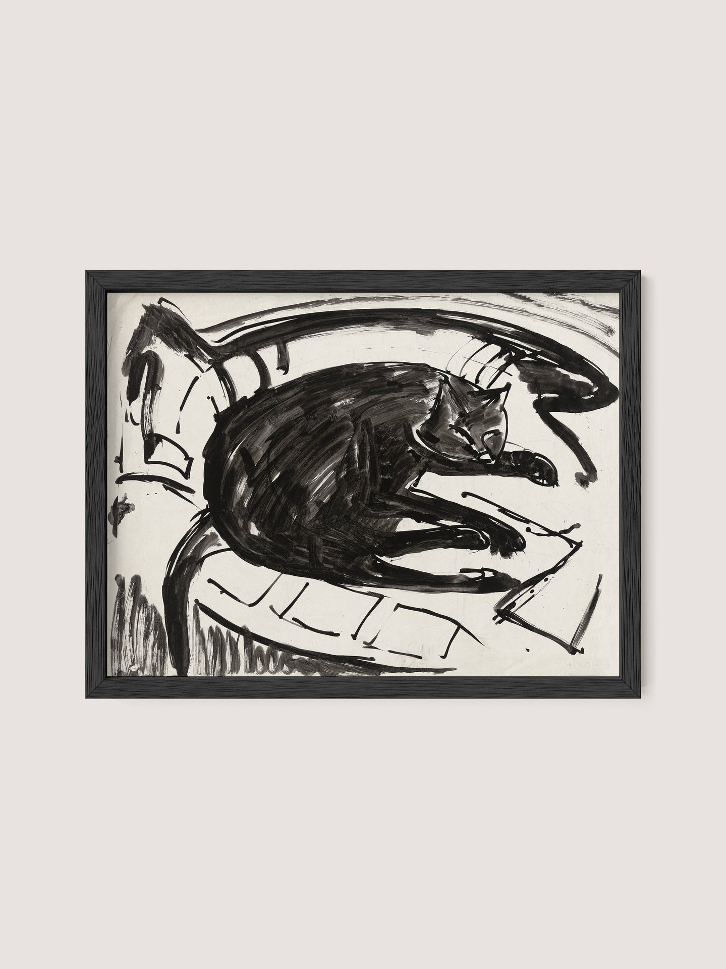 A framed "Lying Cat" print in a Black Oak finish showcases a black and white drawing of a cat lounging on its side against a Kirchner-inspired abstract background. The art style is loose and sketch-like, capturing the relaxed posture of the feline with expressive lines that emphasize the artist's vision.