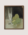 The framed piece titled "Green Apples And Champagne Glass" showcases a minimalist still life scene of a transparent glass and three green apples on a surface, set against a dark backdrop. The artwork exudes timeless elegance with its abstract style, muted earth tones, and soft brushstrokes in walnut oak hues.