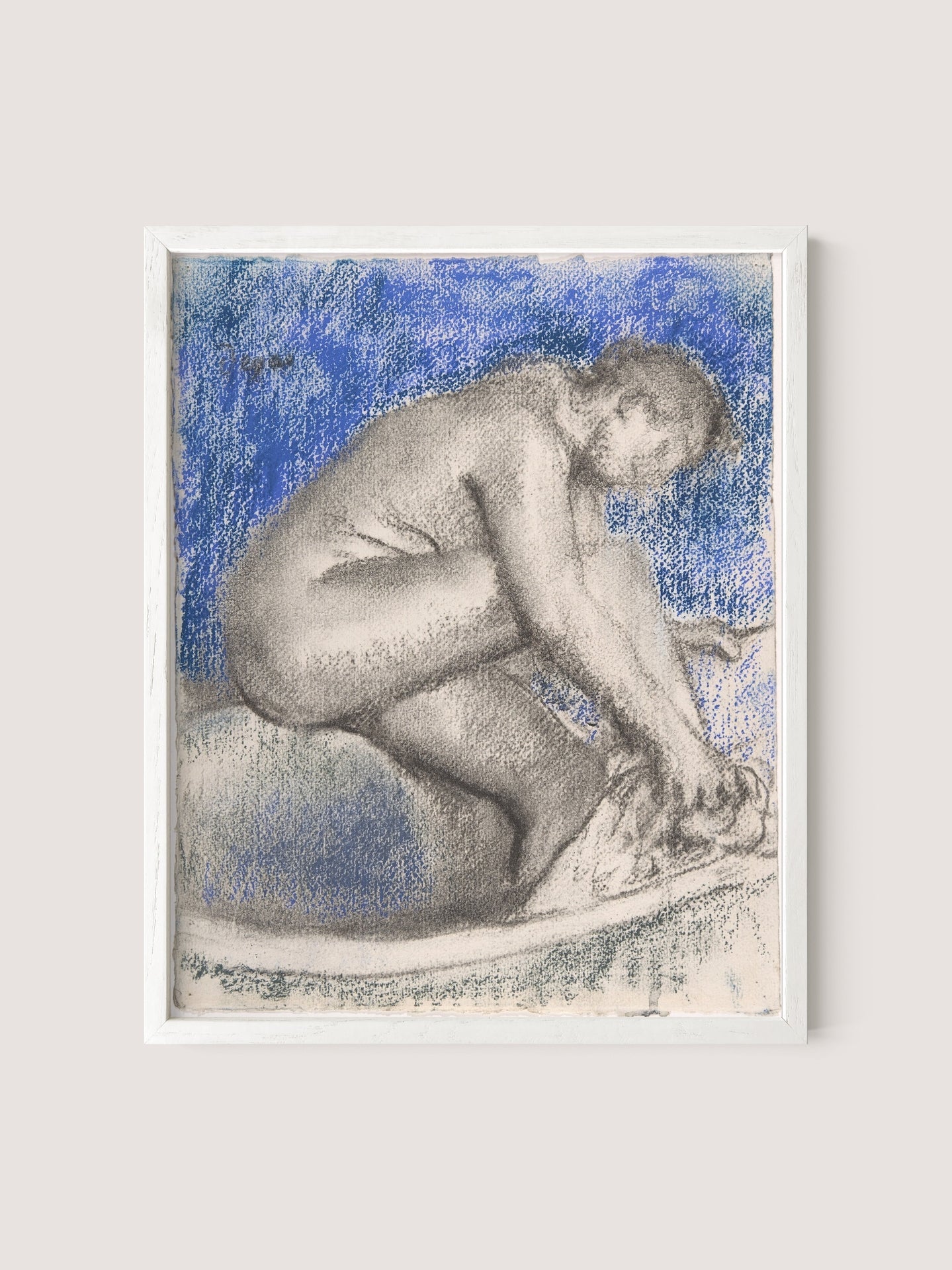 Charcoal and pastel artwork titled &quot;The Bath,&quot; depicting a nude figure kneeling with head bent forward and hands reaching towards the ground, set against a blue and white background. The impressionist style imbues it with refined elegance, further enhanced by a simple white oak frame.