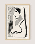 Introducing "Thoughtful Woman," a black and white abstract drawing of a woman with long hair, depicted in a minimalist ink drawing style with bold, flowing lines and contrasting textures. The background features a pattern of small, irregular dots and is framed in elegant Natural Oak—perfect for versatile interior styles.