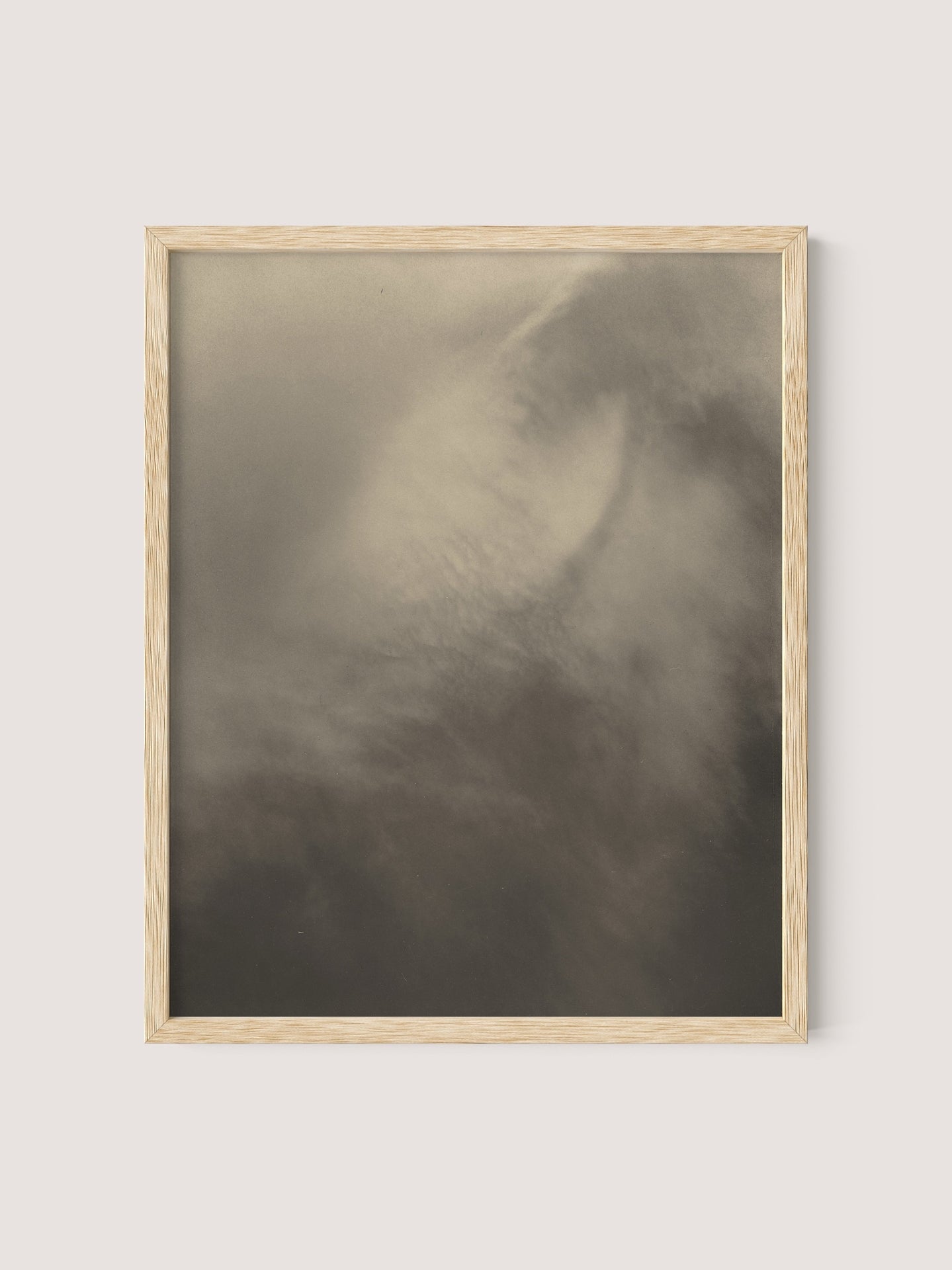 A natural oak-framed photograph titled "Equivalents" displays an abstract and blurred image in shades of gray and white, reminiscent of a mysterious foggy or cloudy scene, evocative of Alfred Stieglitz's "Songs of the Sky" series.