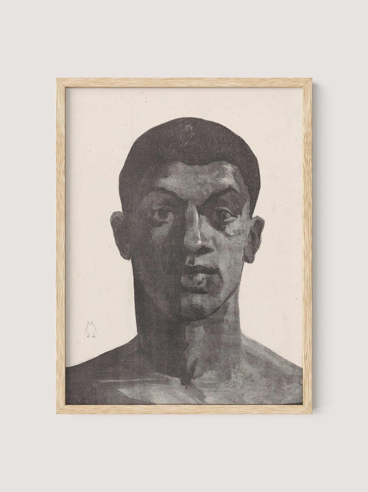 The "Unknown Man" is a framed haunting graphite portrait of a person with a pensive expression. The person has short hair and a muscular build, and the shading expertly emphasizes the facial features. The frame is made of natural oak, capturing the intricate work by acclaimed artist Simon Moulijn.