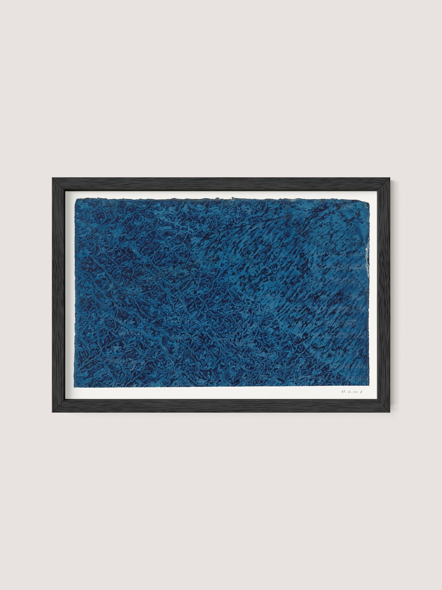 A framed artwork titled "Marbled Blue" featuring mesmerizing patterns in marbled blue. The textures and details within the blue area create a sense of depth and complexity, with the artist's signature visible in the bottom right corner. The frame is simple black oak, enhancing the artwork's prominence.