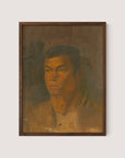 Head of a Gypsy Boy" is a framed painting featuring a solemn-faced man with short dark hair against a muted brown background. Reminiscent of Ladislav Mednyánszky's style, this artwork employs earthy tones and presents a somewhat textured surface that imparts a rustic, unfinished appearance. The portrait exudes sophisticated timeless décor as the man gazes forward with a serious expression. The frame in Walnut Oak completes this striking piece, adding to its elegance and charm.