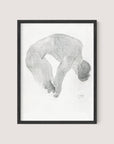 The "Bending Nude" is a framed artwork featuring a pencil sketch of a nude figure in a balletic pose, curled over with legs bent and arms reaching towards the feet. This intimate portrait by artist Reijer Johan Antonie Stolk showcases a minimalist and abstract style against a white background, encased in an elegant Black Oak frame.