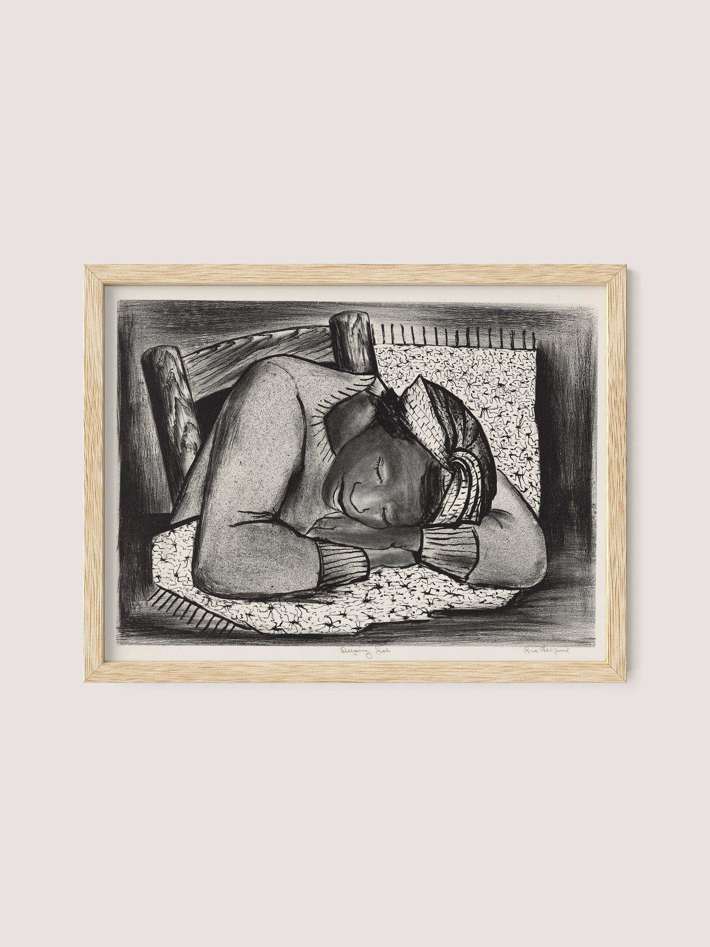 A framed sketch titled "Sleeping Girl" by Riva Helfond, set in a natural oak frame, depicts a person resting their head on folded arms atop a quilt. They are wearing a headscarf and long-sleeved top. The background includes a wooden headboard, capturing the peacefulness and rest often celebrated in the Works Progress Administration’s artistic revival.