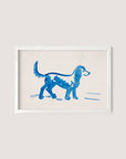 A framed watercolor painting titled "Great Dane" by Peter Weisz Kubínčan depicts a blue dog walking to the right. The artwork showcases simple, fluid brushstrokes on a light beige background, incorporating shades of blue that add a touch of elegance to any space with its white oak hues.