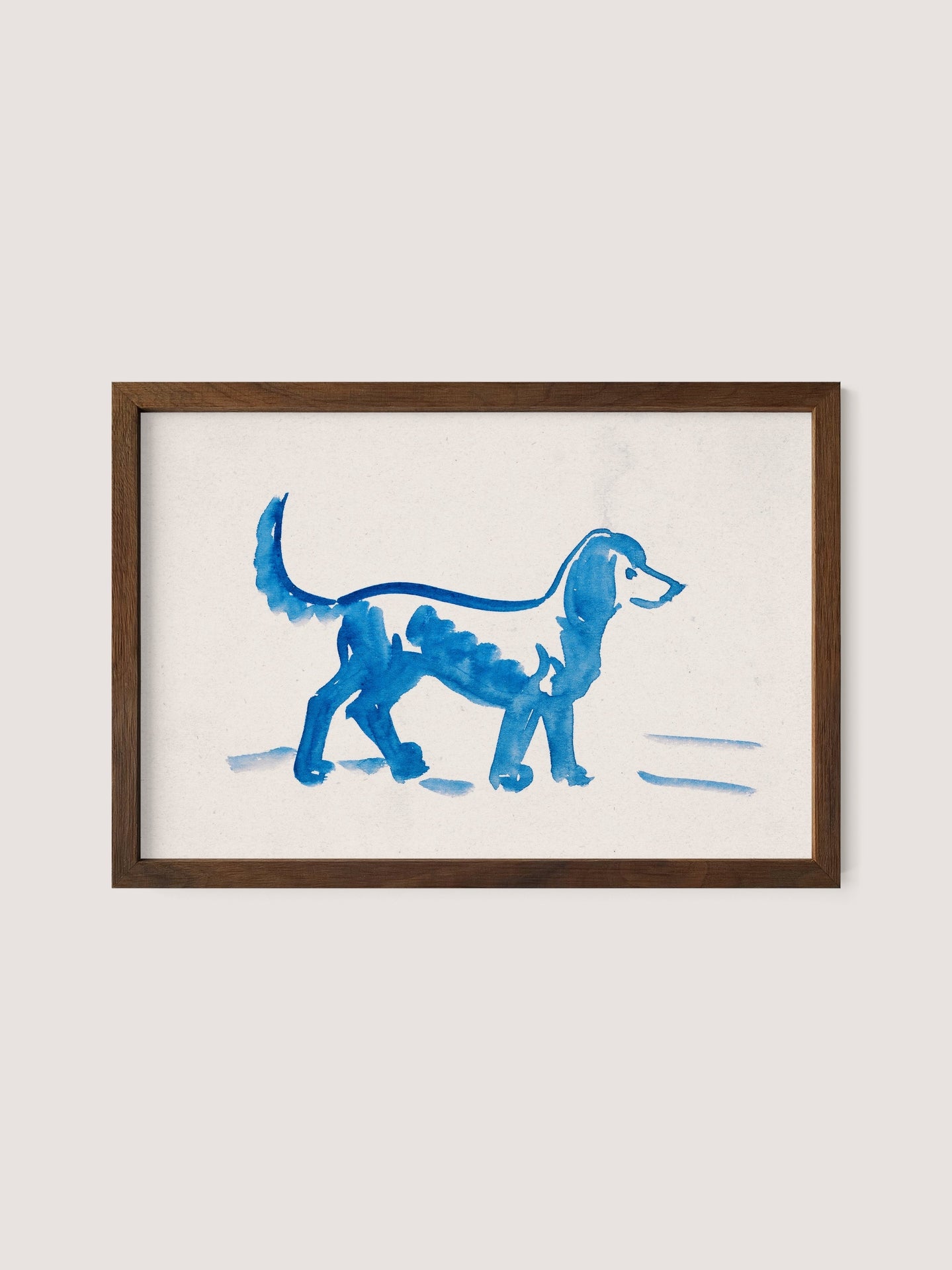 A framed artwork by Peter Weisz Kubínčan, titled &quot;Great Dane,&quot; depicts a simplistic painting of a blue Great Dane walking, rendered with broad, fluid brushstrokes on a white background. The walnut oak wooden frame contrasts with the minimalistic and playful style of the painting, making it perfect for blue-toned decor.